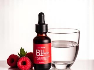 Vitamin B12 droppers and a glass of water